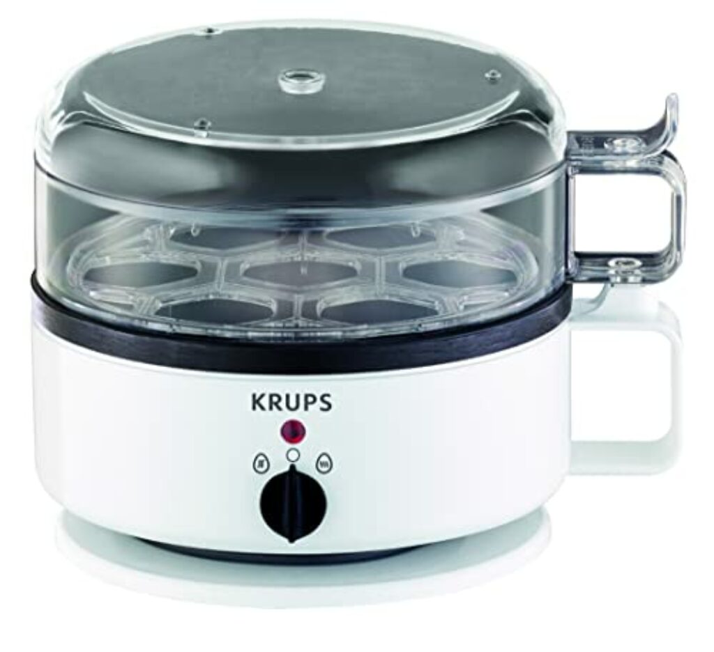 Krups F23070 Eierkocher mit Wasserstandsanzeige | Für bis zu 7 Eier | Koch- und Warmhaltefunktion | inkl. Wasser-Messbecher mit Eierstecher | Eierhalter | Signalton | BPA-frei | Weiß